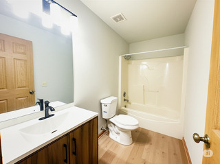 416 Fawn Lane Oswego, IL 60543 - Photo 10 of 13 a bathroom with a sink a toilet and shower