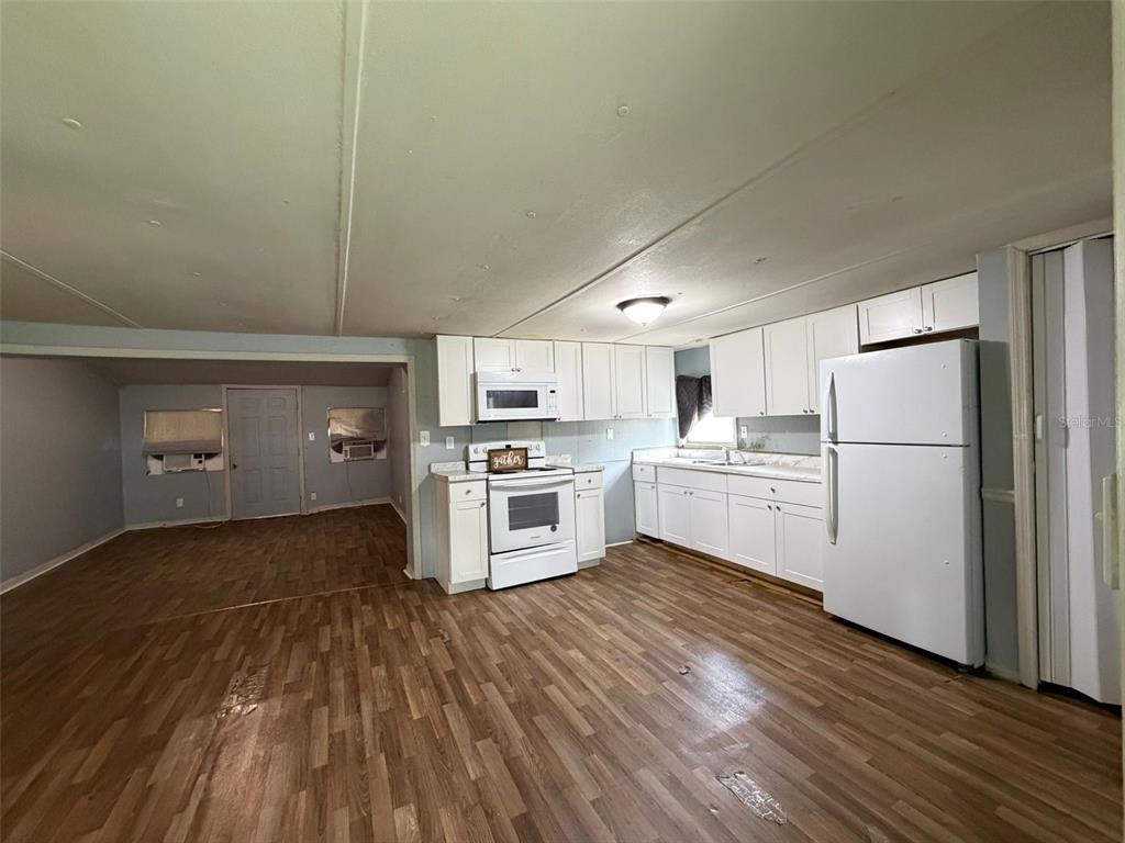5071 Hibiscus Road Kissimmee, FL 34746 - Photo 3 of 12 a kitchen with white cabinets and white appliances