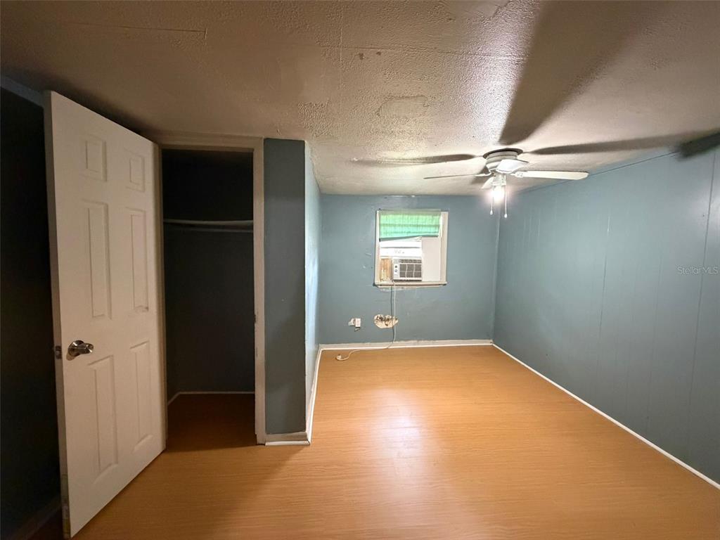5071 Hibiscus Road Kissimmee, FL 34746 - Photo 5 of 12 an empty room with closet and windows