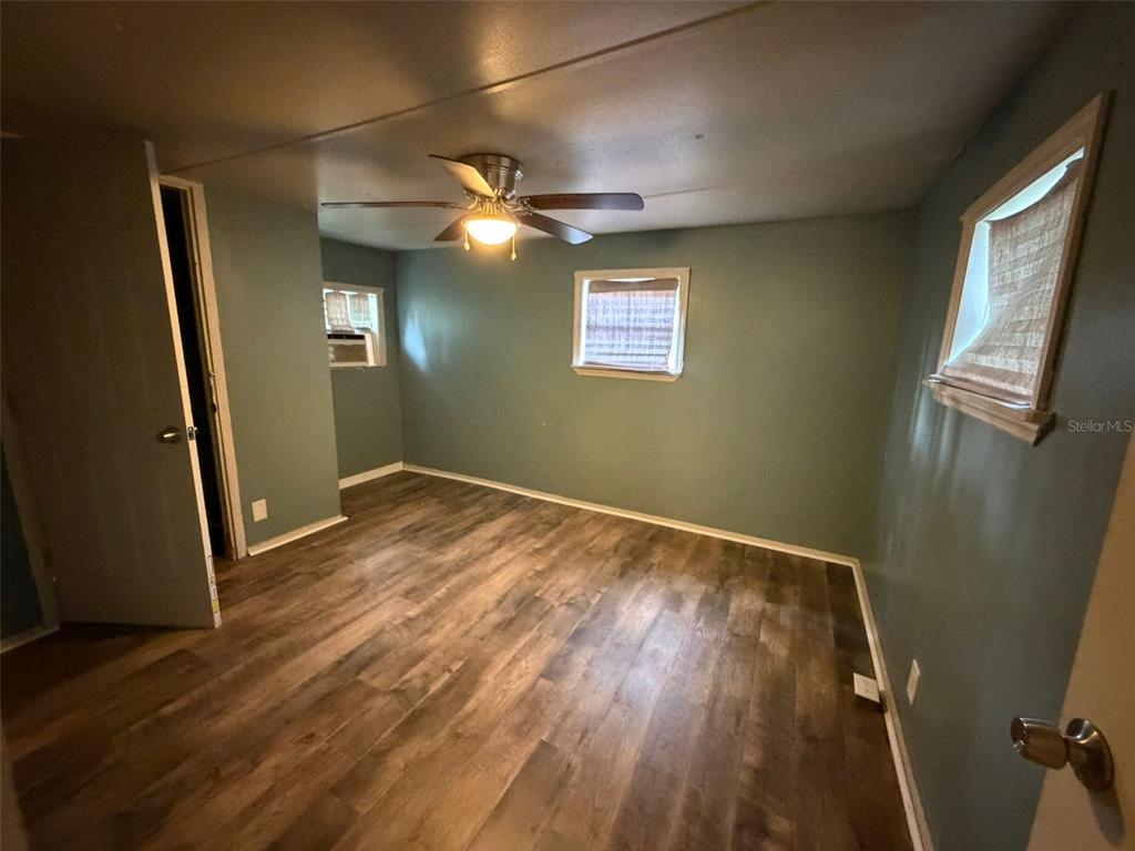 5071 Hibiscus Road Kissimmee, FL 34746 - Photo 6 of 12 a view of empty room with wooden floor