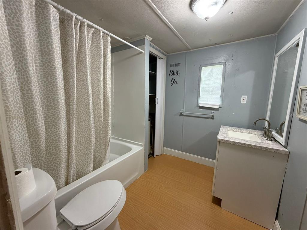 5071 Hibiscus Road Kissimmee, FL 34746 - Photo 7 of 12 a bathroom with a sink toilet and shower