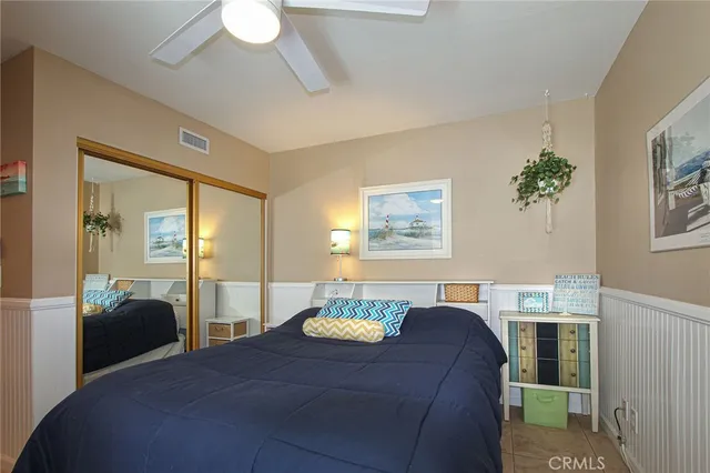 a bedroom with a bed and a dresser in it