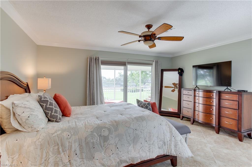 195 Harrison Road, Unit 4 Naples, FL 34112 - Photo 13 of 31 Large primary bedroom, tastefully furnished!
