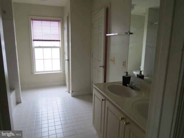 2126 Queensguard Road Silver Spring, MD 20906 - Photo 12 of 25 a bathroom with a sink a vanity and a mirror