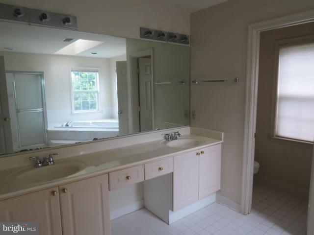 2126 Queensguard Road Silver Spring, MD 20906 - Photo 18 of 25 a bathroom with a granite countertop sink and a mirror