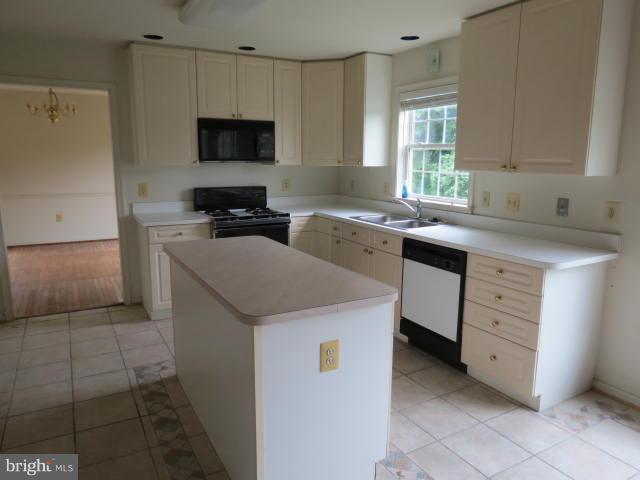 2126 Queensguard Road Silver Spring, MD 20906 - Photo 3 of 25 a kitchen with a sink stove and cabinets
