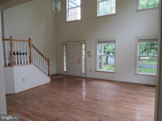 2126 Queensguard Road Silver Spring, MD 20906 - Photo 6 of 25 a view of an empty room with wooden floor and a window