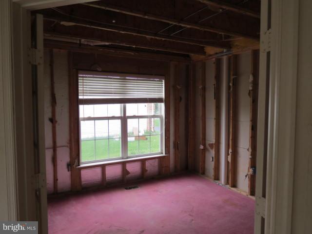 2126 Queensguard Road Silver Spring, MD 20906 - Photo 8 of 25 a view of an empty room with a window and a door