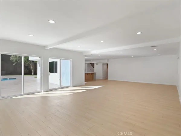 a view of an empty room with glass door