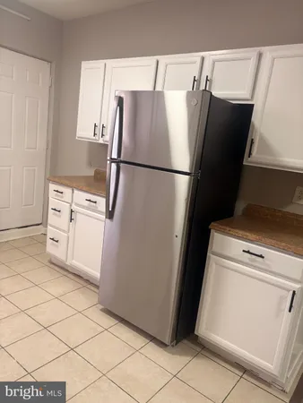 a utility room with cabinets washer and dryer
