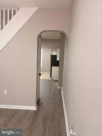 a view of a hallway with wooden floor
