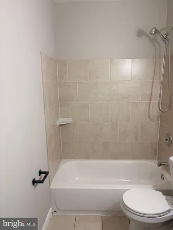 a bathroom with a toilet and bathtub