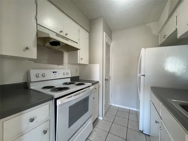 a kitchen with stainless steel appliances granite countertop a stove and a refrigerator