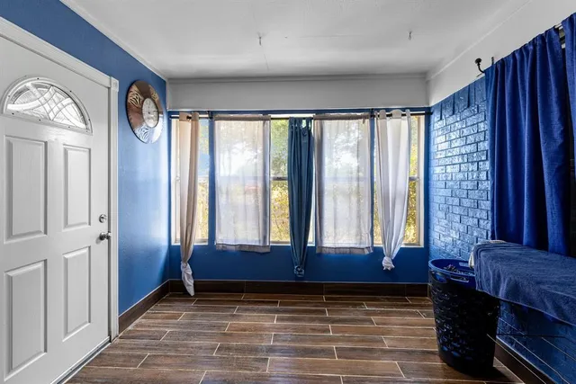 a view of front door with hallway and a window