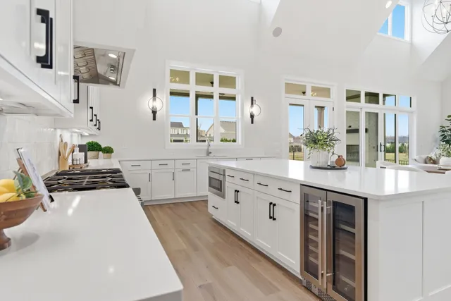 a kitchen with stainless steel appliances a sink stove and cabinets