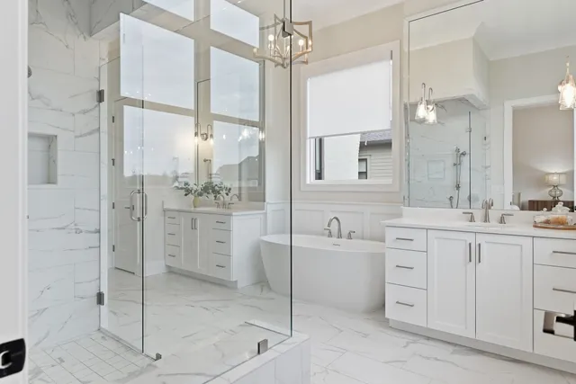 a bathroom with a double vanity sink mirror and shower