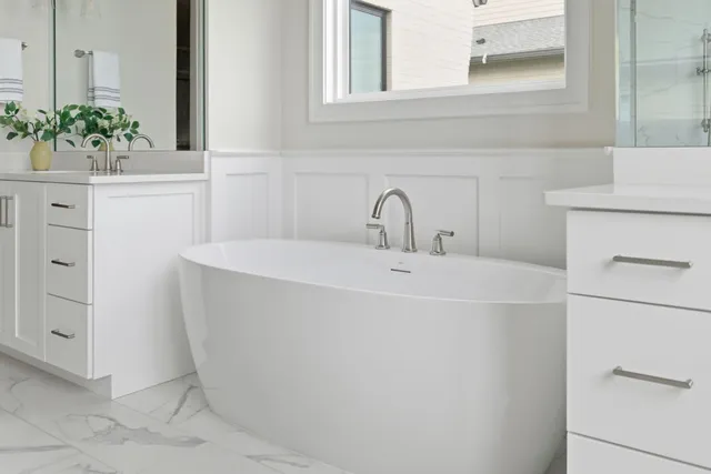 a close view of a sink and a vanity in the mirror
