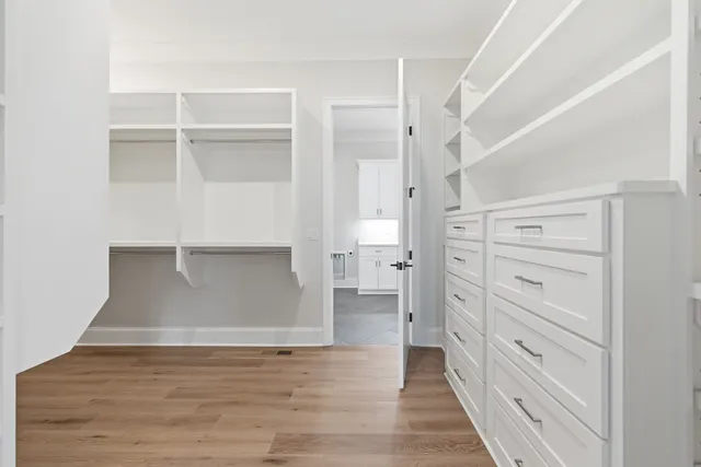 a view of walk in closet with empty racks