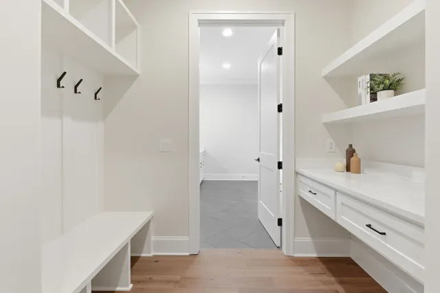 a view of hallway with white cabinets