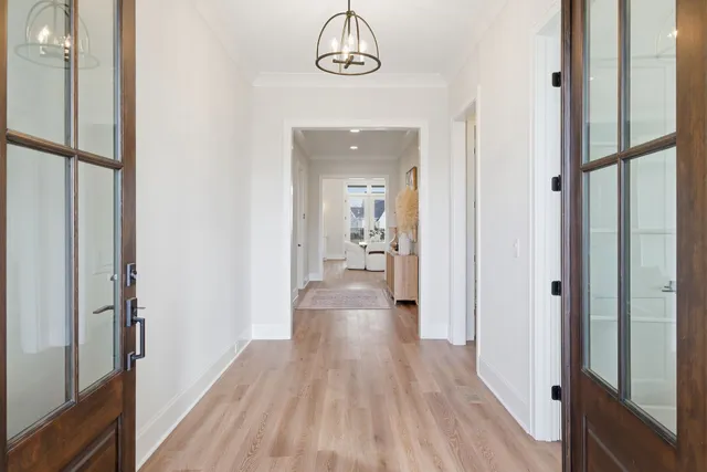 a view of a hallway with wooden floor