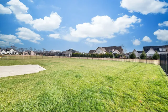 a view of a lake with houses in the back