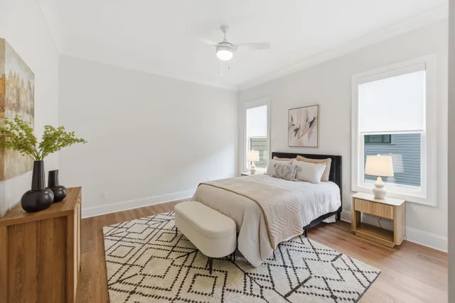a bedroom with a bed and a potted plant