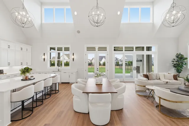 a living room with couches chairs and couches with wooden floor