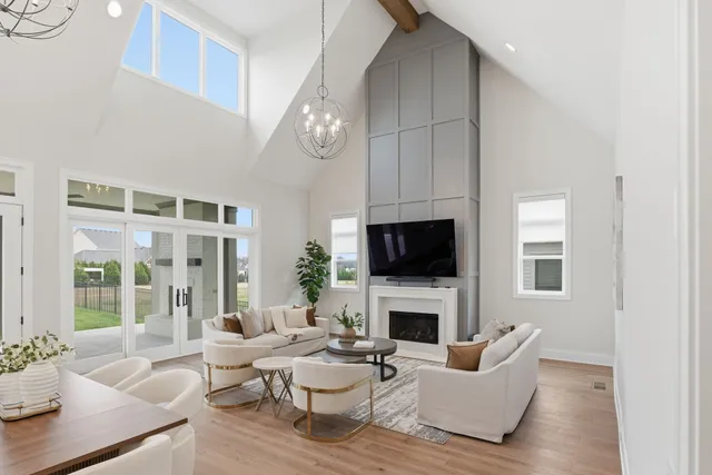 a living room with furniture a fireplace and a flat screen tv