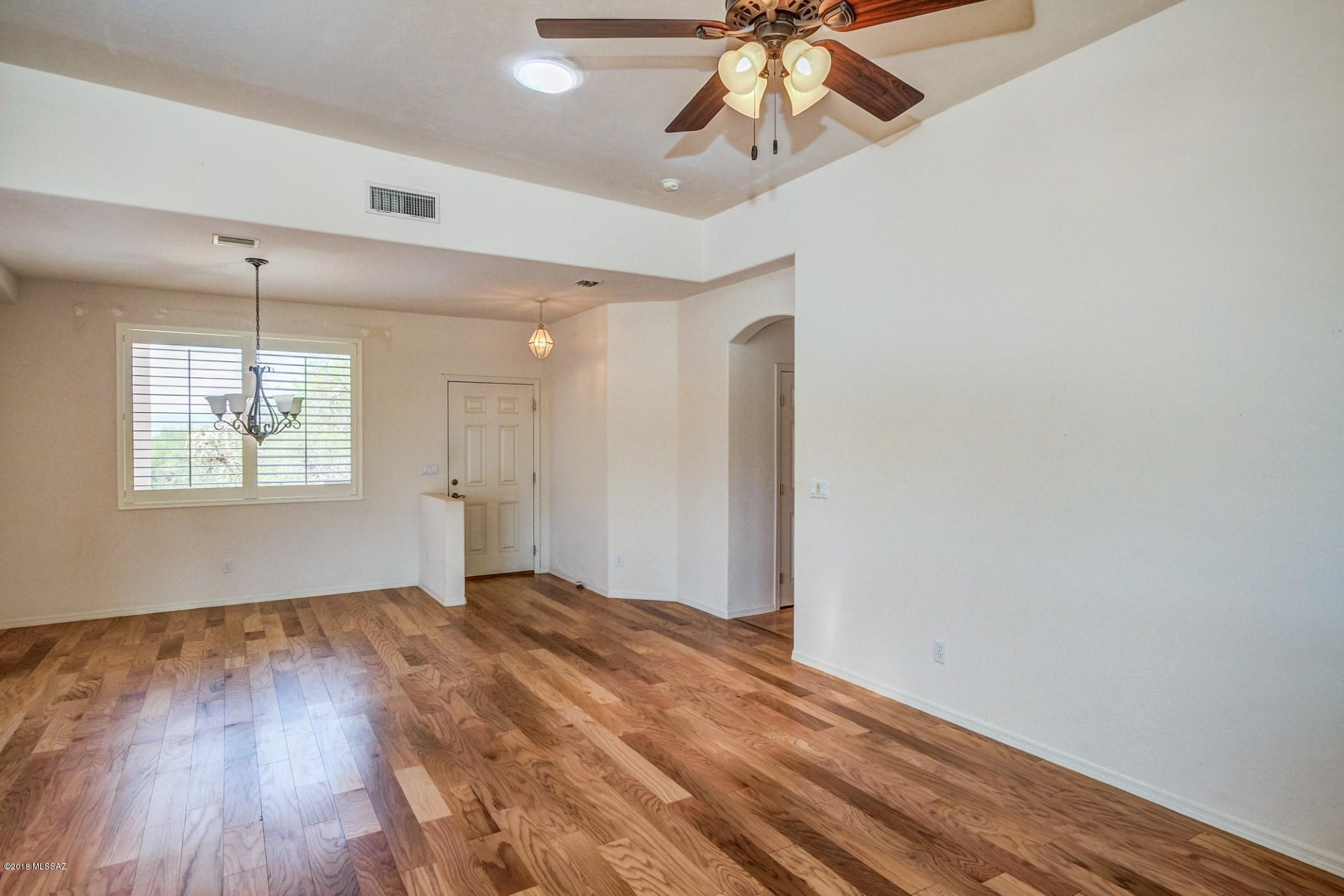 14480 North Swan Road Tucson, AZ 85739 - Photo 6 of 31 wooden floor in an empty room with a window