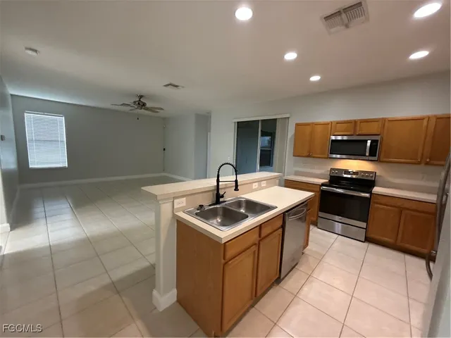 a kitchen that has a sink and a stove top oven