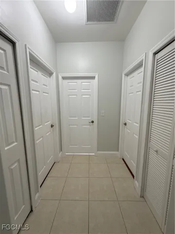 a view of hallway with a bathroom and a sink