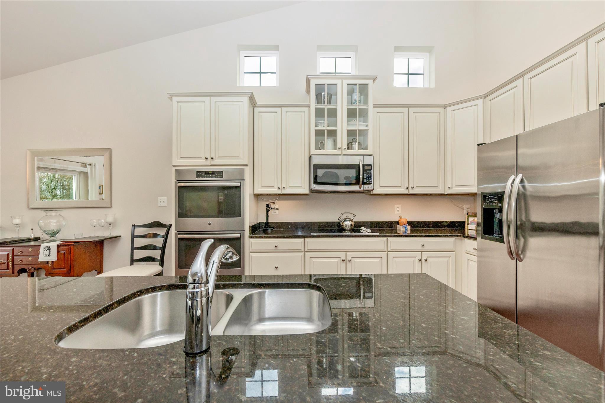 5903 Constance Way New Market, MD 21774 - Photo 13 of 53 a kitchen with stainless steel appliances granite countertop a sink refrigerator and microwave