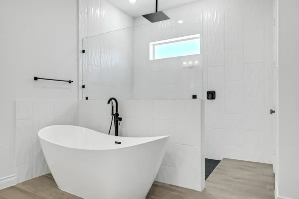 a white bath tub sitting in a bathroom
