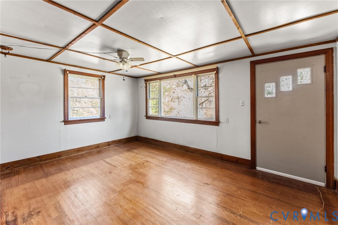 19161 Hollowing Creek Road Beaverdam, VA 23015 - Photo 18 of 27 a view of a big room with wooden floor and windows