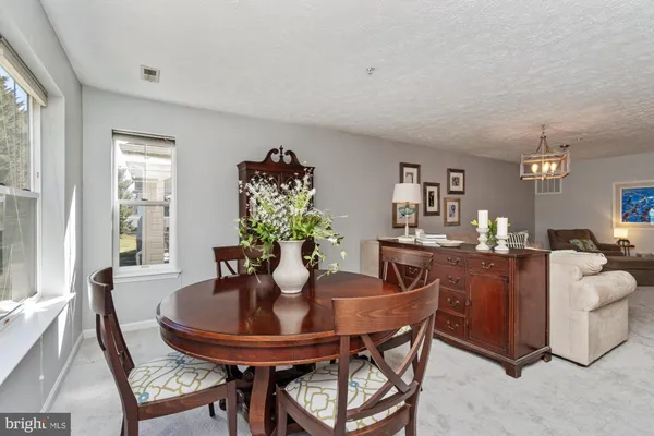 a view of a dining room with furniture and window