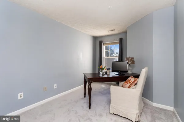 a living room with furniture and a lamp