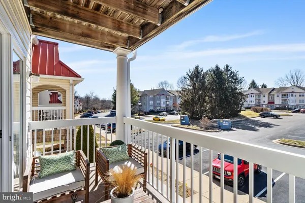 a view of balcony with wooden floor and outdoor seating
