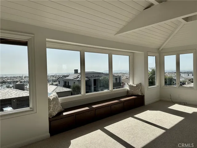 a living room with furniture and a floor to ceiling window
