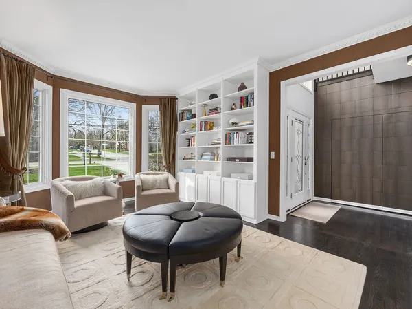 a living room with furniture and a floor to ceiling window