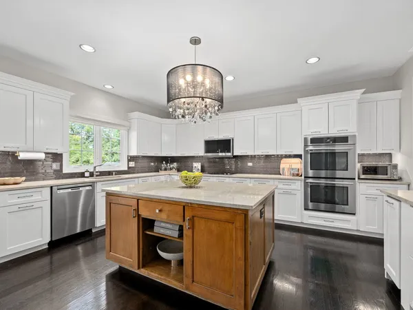 a kitchen with stainless steel appliances granite countertop a stove oven and a white refrigerator