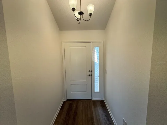 a view of a room with a sink and a mirror