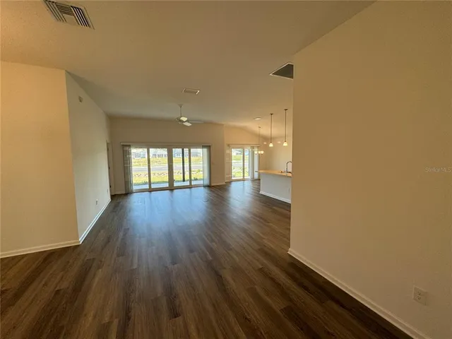 a view of an empty room and wooden floor