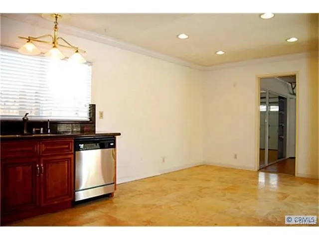 a kitchen with stainless steel appliances granite countertop a sink and a stove
