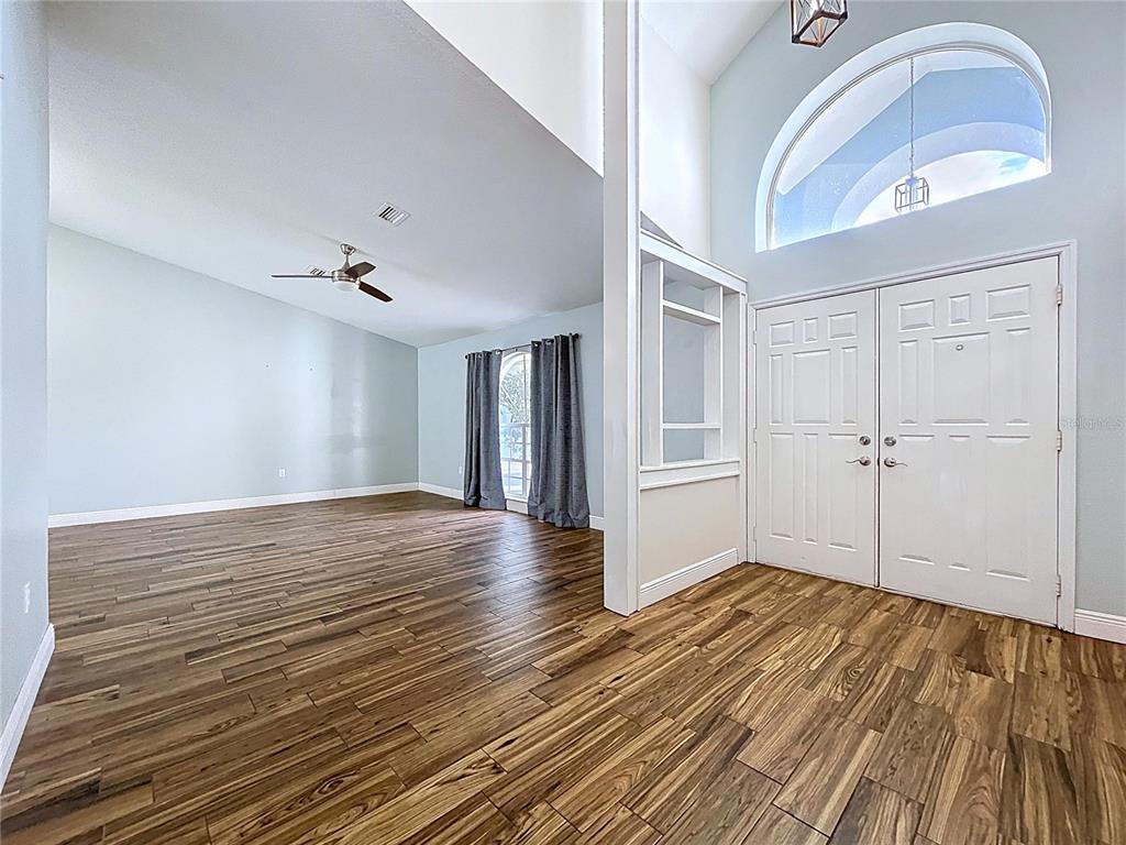 18812 Bascomb Lane Hudson, FL 34667 - Photo 15 of 57 a view of empty room with wooden floor