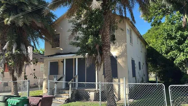 a view of a house with a iron gate
