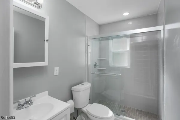 a white toilet sitting next to a bathroom sink