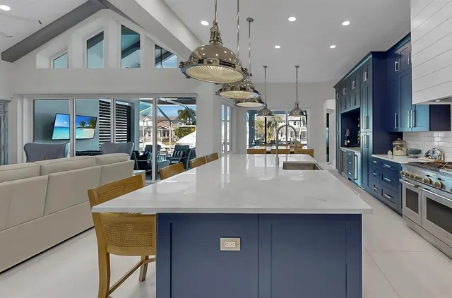 a bedroom with a bed dresser and a chandelier