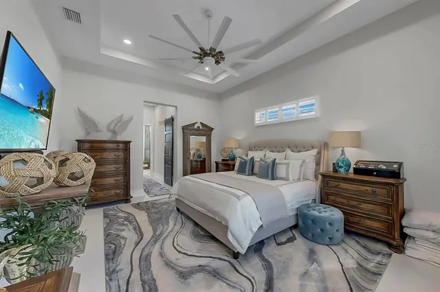 a view of a white house with a large tree