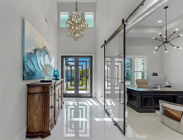 a living room with furniture a ceiling fan and a window
