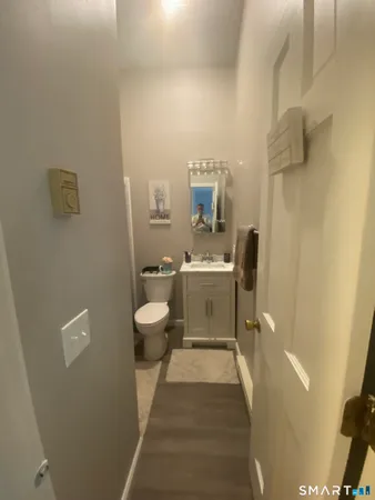 a bathroom with a sink a toilet and a shower